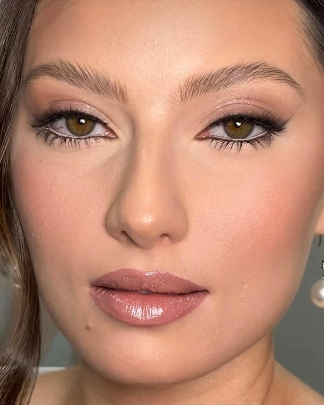 Editorial bridal makeup with soft glam and gloss.